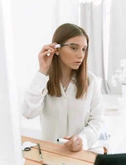 Applying Eyebrow Gel woman applying eyebrow gel